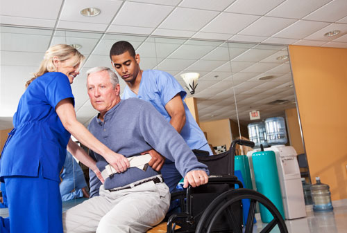 Helping patient into wheelchair