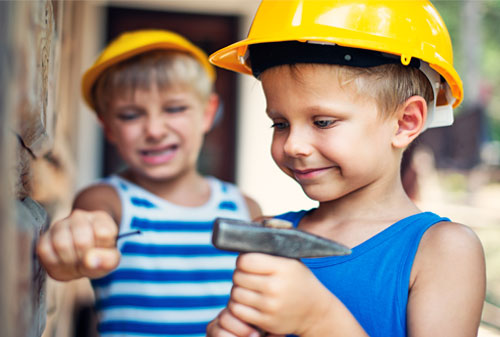 Children hammering nail