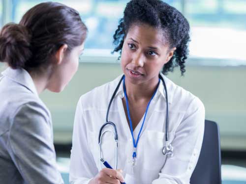 A doctor listening to a patient