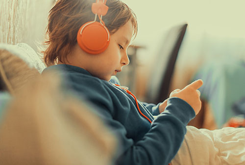 A child in bed on their phone