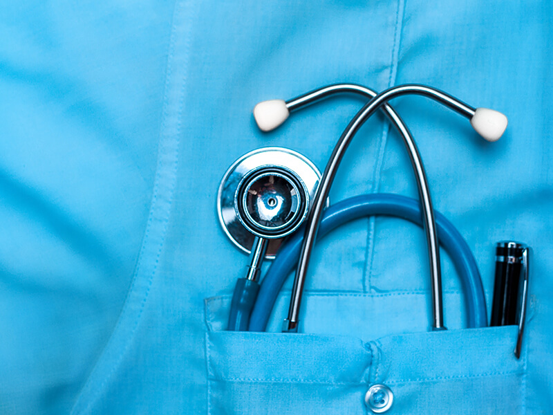 Doctors stethoscope and tools in breast pocket