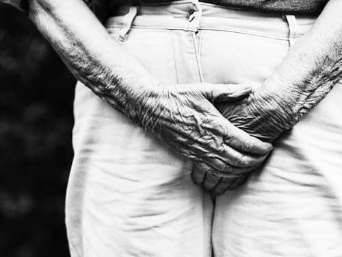 Man clutching trousers