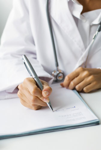 Doctor signing forms
