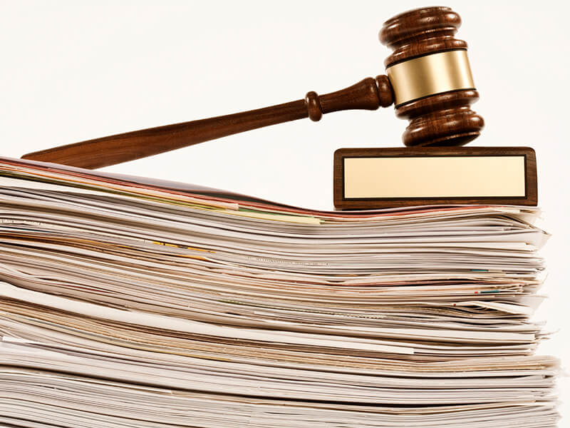A pile of legal documents and a gavel